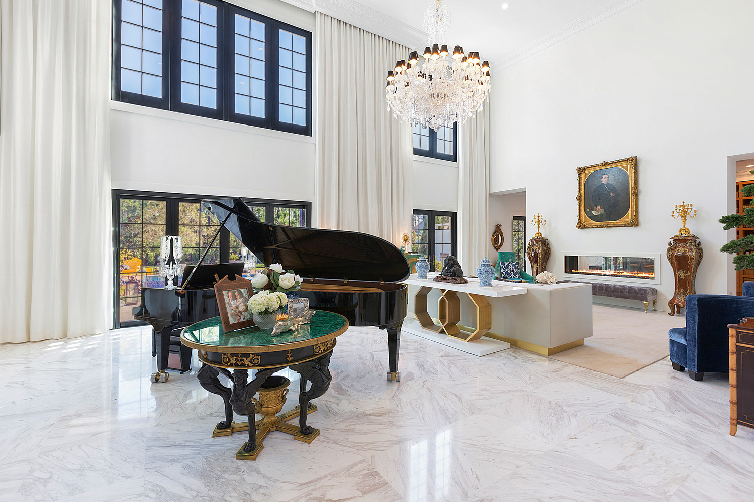 This room features a grand piano that was built for Julie Andrews and a Russian Empire malachite table with a dore and ebonized bronze base, among several other attractions.